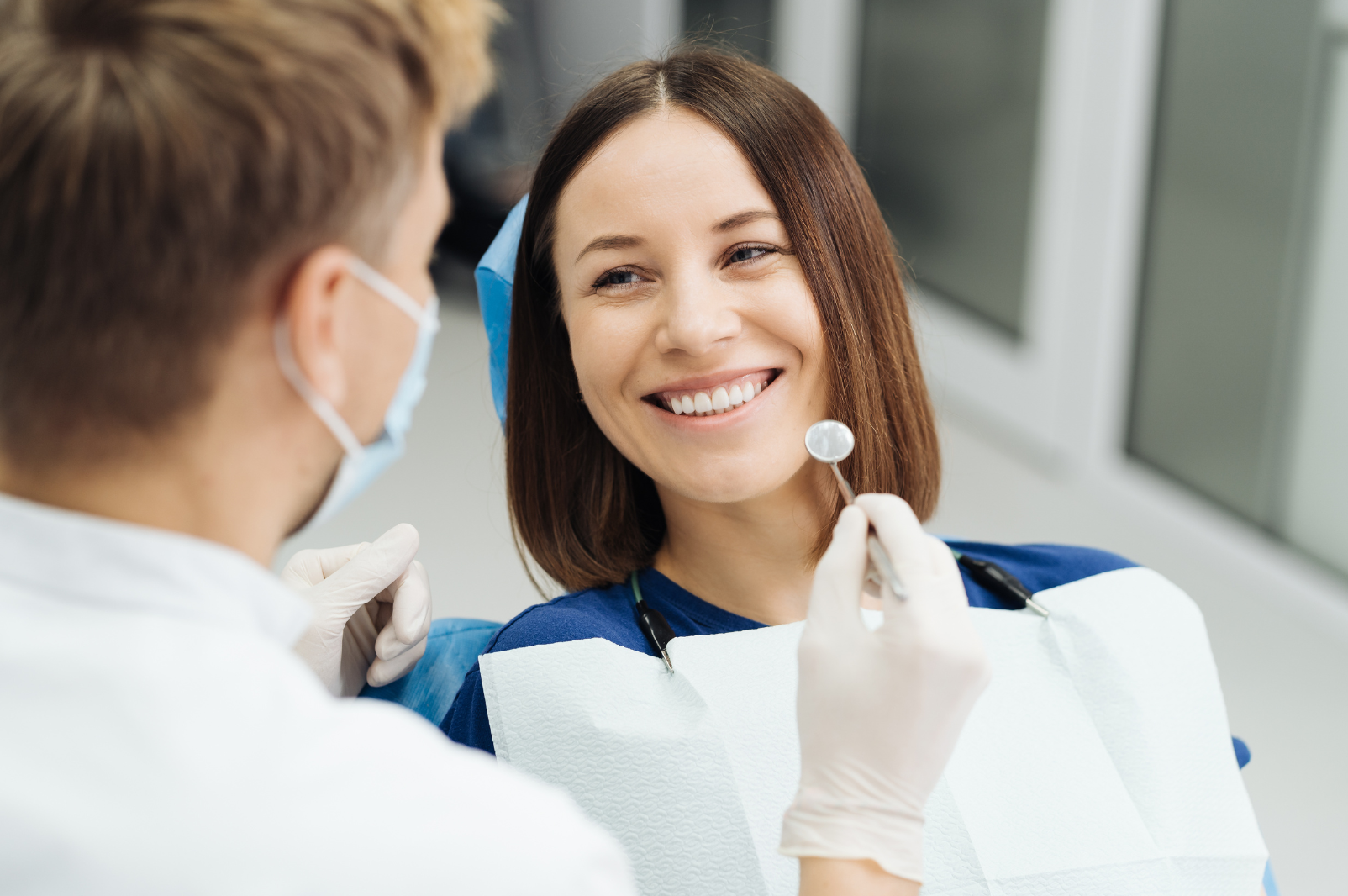 young woman smiling at dentist